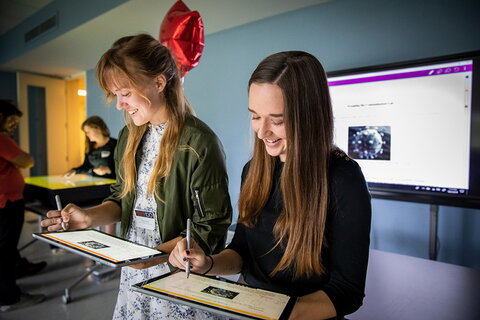 two students on tablet computers