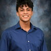 Prajeet Basu Smiling on a gray background