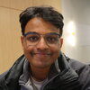 Aditya Ramesh Smiling at the camera from inside a classroom