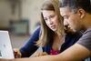 A graduate student writing consultant mentors another graduate student in a grad writing productivity group, sponsored by the Writers Workshop.