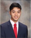 A young man in a suit smiling