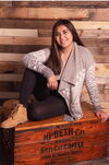 A young lady posing on a wooden crate 