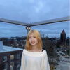 A female standing on glass balcony