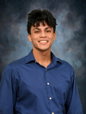 Prajeet Basu Smiling on a gray background
