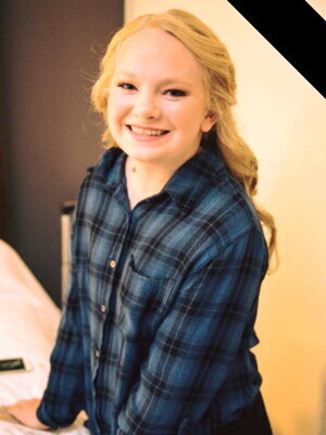 Natalie Smiling and wearing a blue top