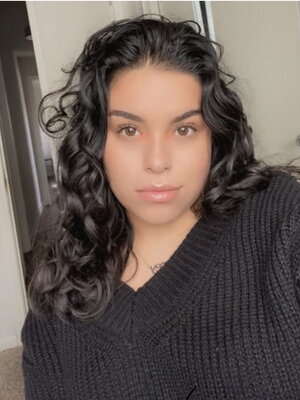 A woman in a black shirt and curly hair