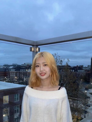 A female standing on glass balcony