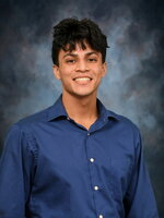 Prajeet Basu Smiling on a gray background