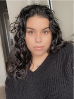 A woman in a black shirt and curly hair