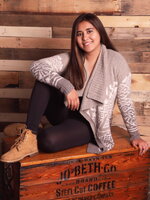 A young lady posing on a wooden crate 