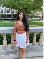 A female college student in white skirt and pink shirt